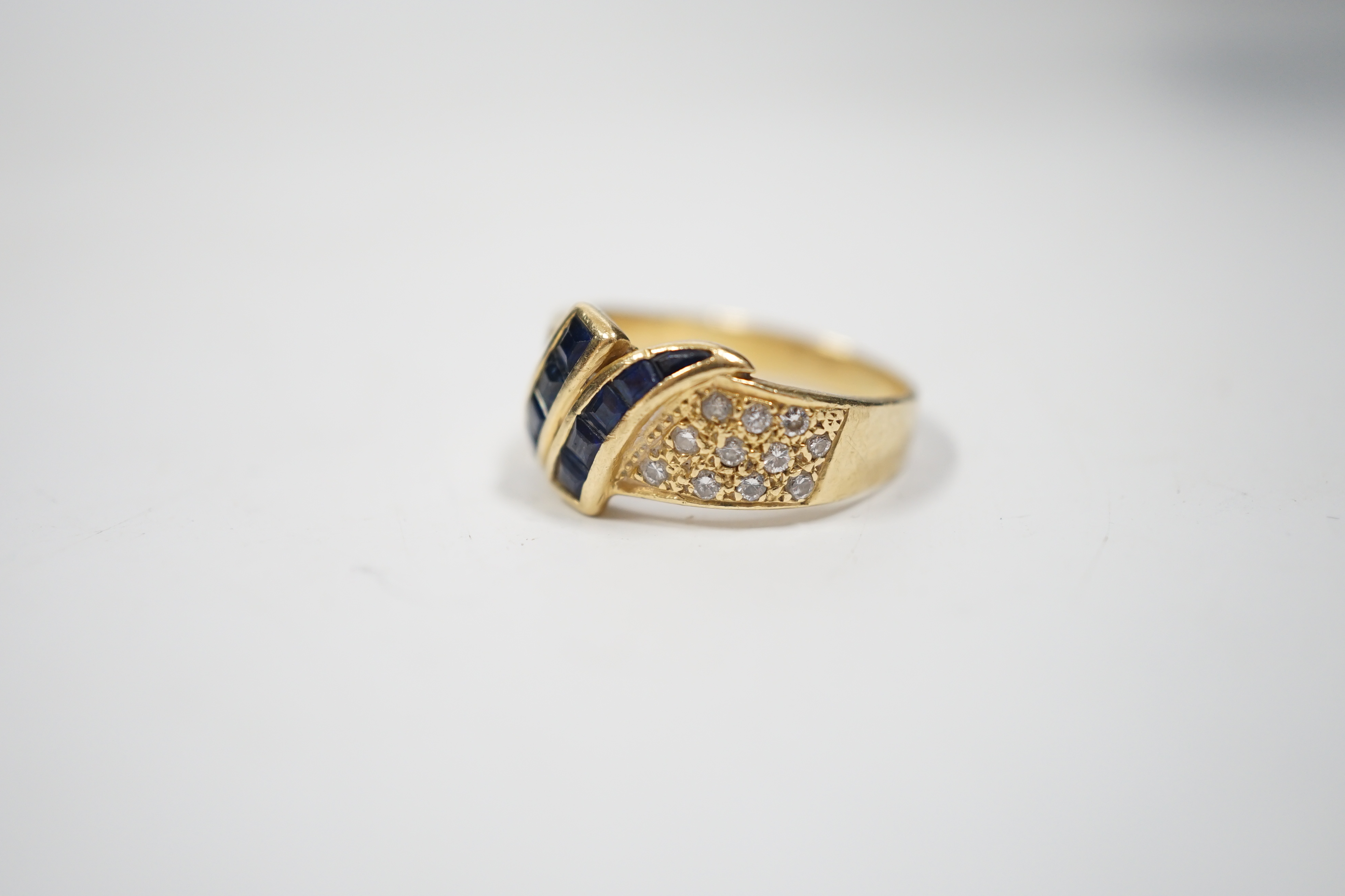 A modern 750 yellow metal, sapphire and diamond chip set dress ring, size K, gross weight 4.8 grams.